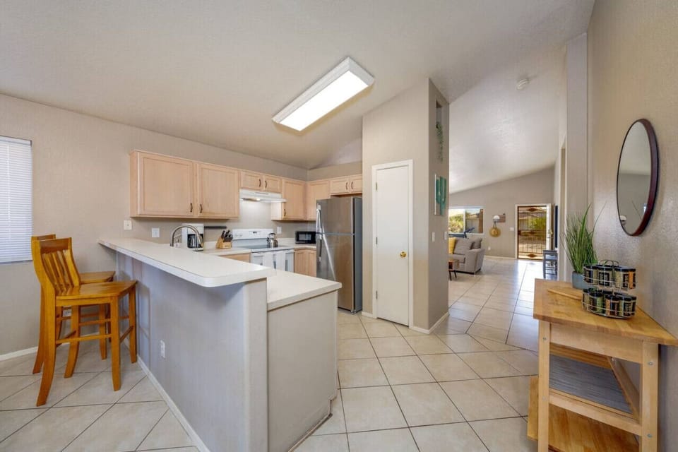 View of kitchen and front entrance that leads into the primary living room space