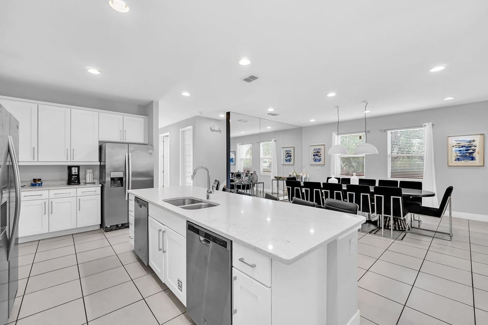 Modern and spacious kitchen with a large center island, stainless steel appliances, and ample seating, perfect for socia