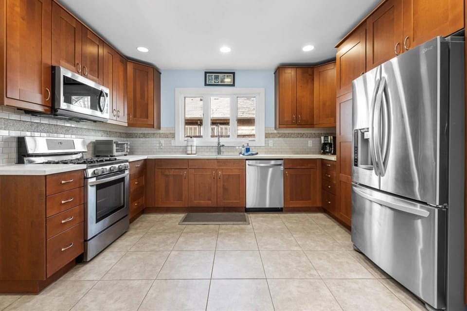 Fully-equipped kitchen with stainless steel appliances and gas range