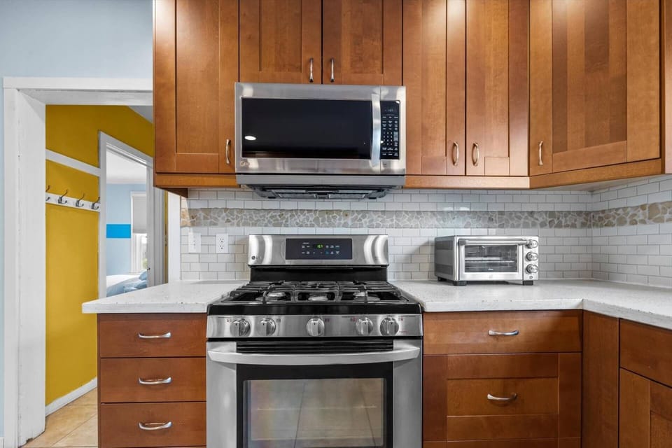 Fully-equipped kitchen with stainless steel appliances and gas range