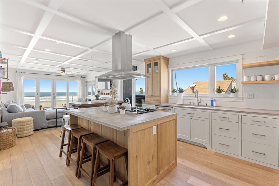 This centrally located Kitchen, seamlessly integrated with casual seating in the heart of the living area, blends contemporary, high-end luxury design with a classic twist—perfect for a family getaway.