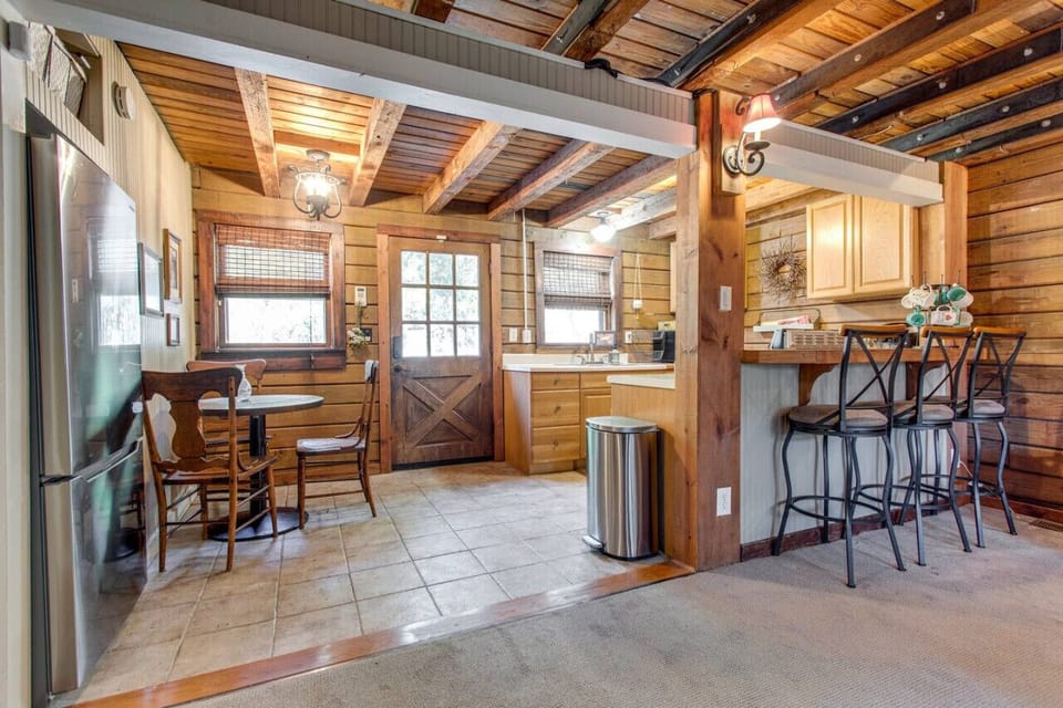 You enter into the kitchen. We have a small indoor dining area and bar stools.