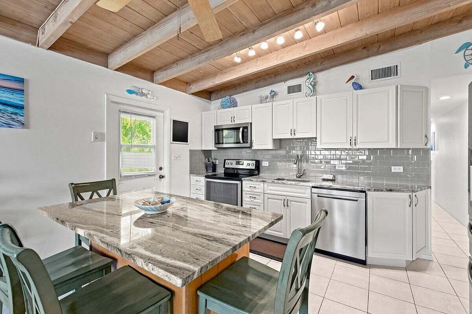 The open kitchen offers ample preparation space and easy access to the dining table for relaxed vacation meals.
