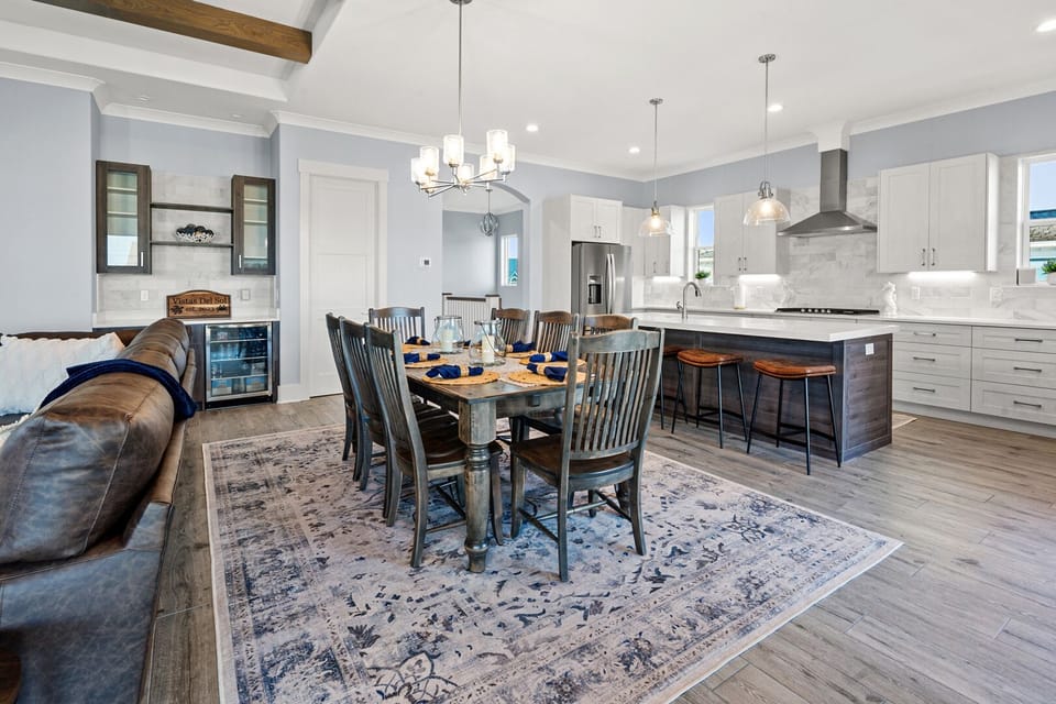Dining table for six with the kitchen just behind at Vistas Del Sol in Tilghman Beach, North Myrtle Beach