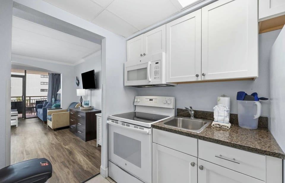 Updated kitchen featuring a modern stove and sleek white cabinetry