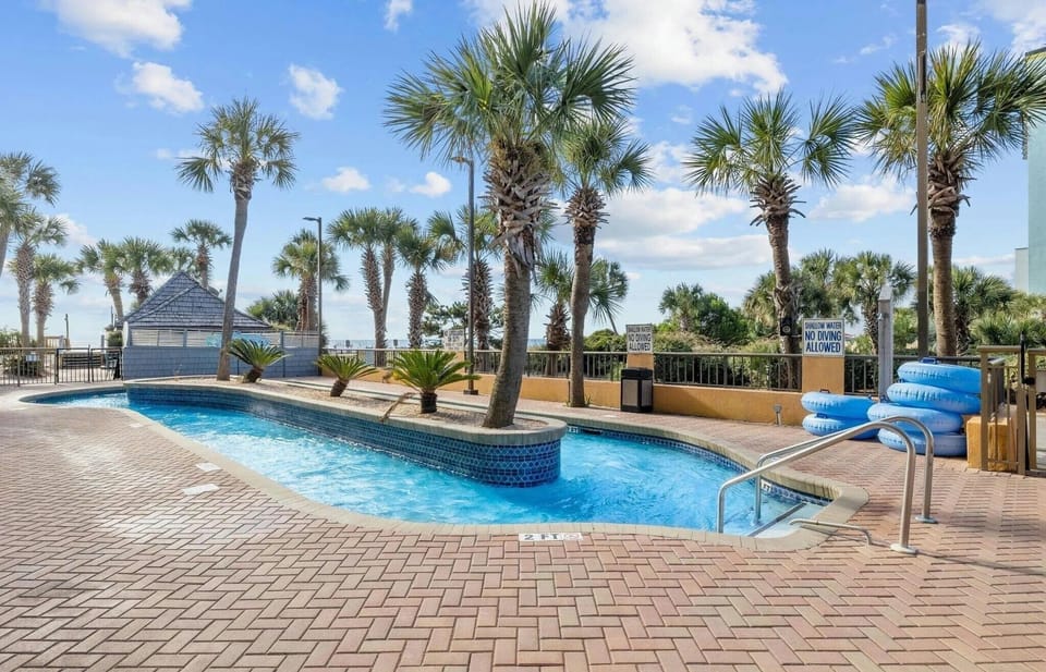 Enjoy a peaceful float along the lazy river framed by palm trees