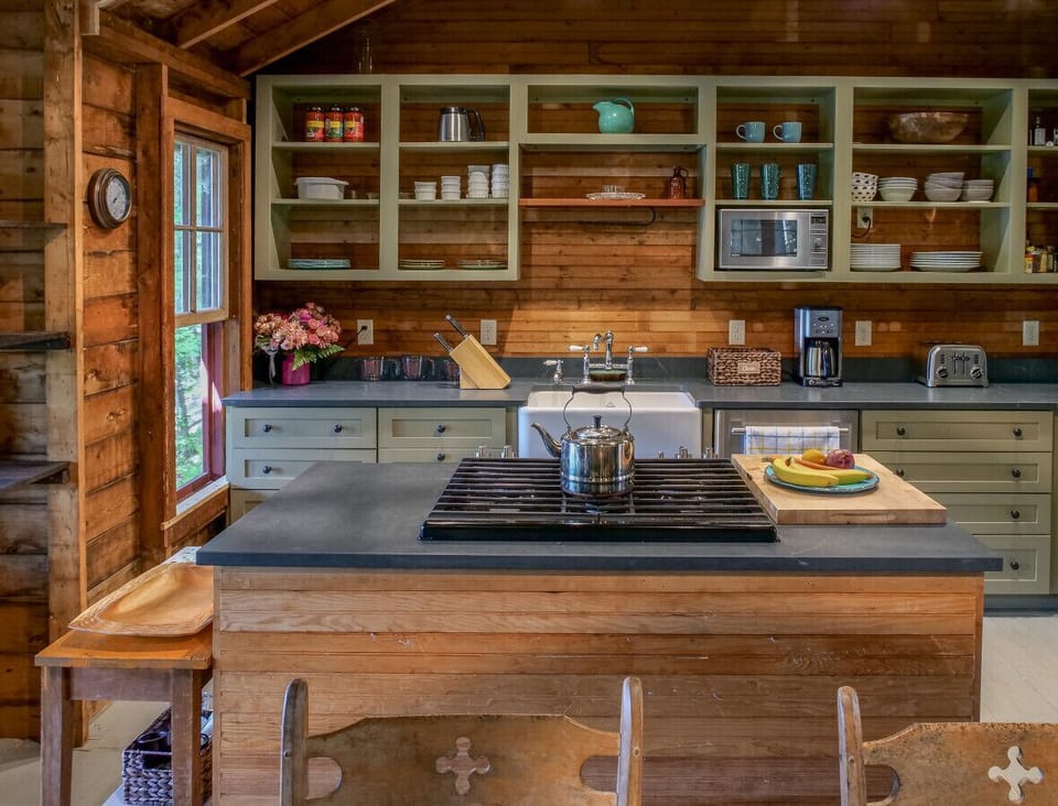 View of the modern kitchen with gas 5 burner stove and large oven, farmhouse sink, micro, dishwasher and oversized fridge