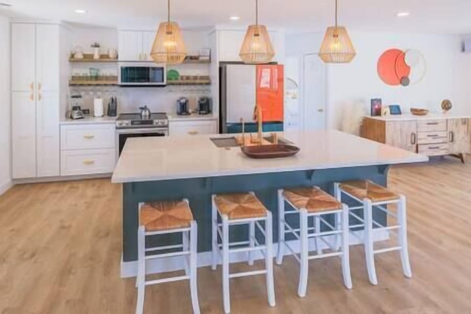 Custom Kitchen: The heart of the home is the modern appliance and bar to share all the good times! 
