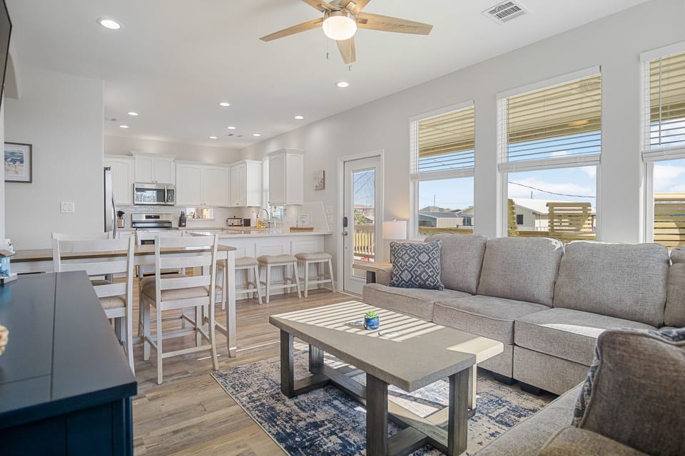 Open concept living room w/ 65" smart TV.