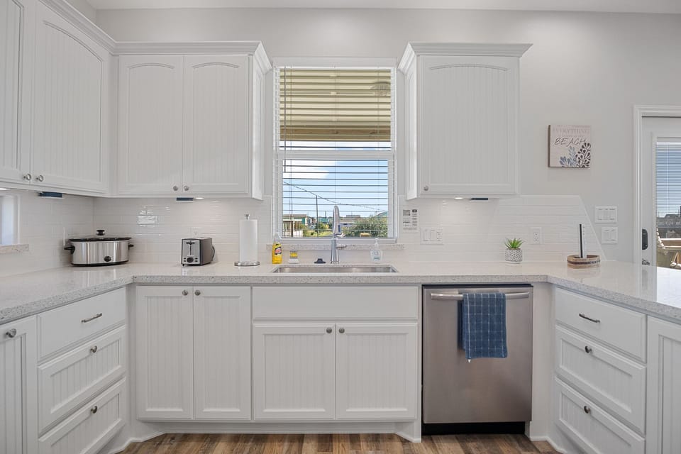Clean kitchen open to living area.