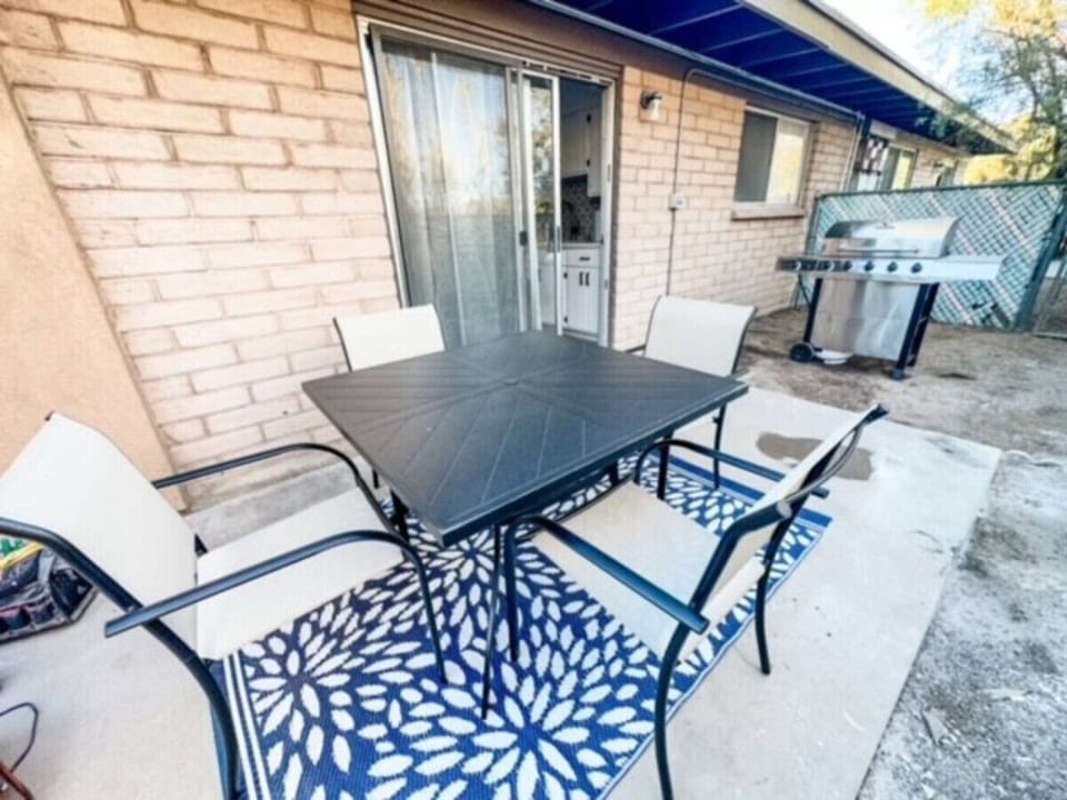 Outdoor patio with table that seats four and new propane grill