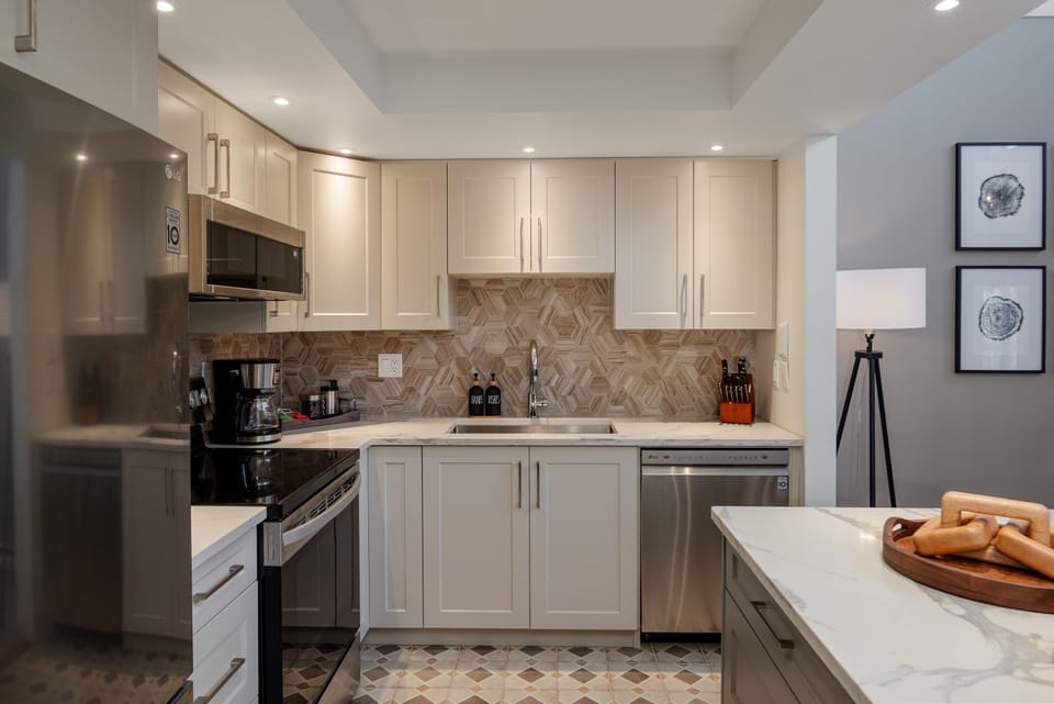 Kitchen - Fully stocked with essential appliances including dishwasher, oven, microwave and coffee maker
