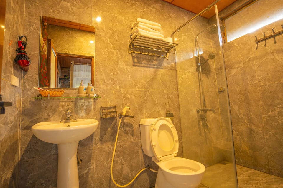Deep soaking tub, hydromassage showerhead, designer toiletries
