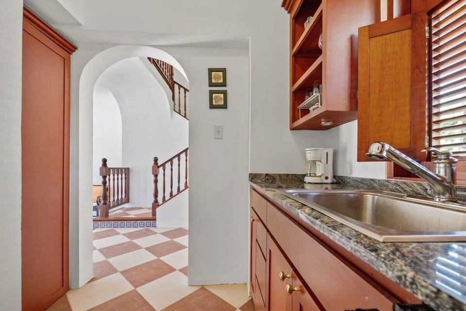It offers a small refrigerator, toaster, microwave oven, a single burner portable stovetop, coffee maker, a blender, and basic pots and pans for simple cooking.
