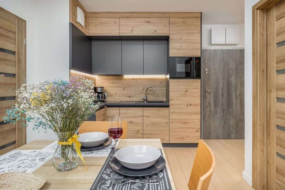 Another angle of the kitchen with a focus on storage and countertop space, maintaining a clean and organized look.

