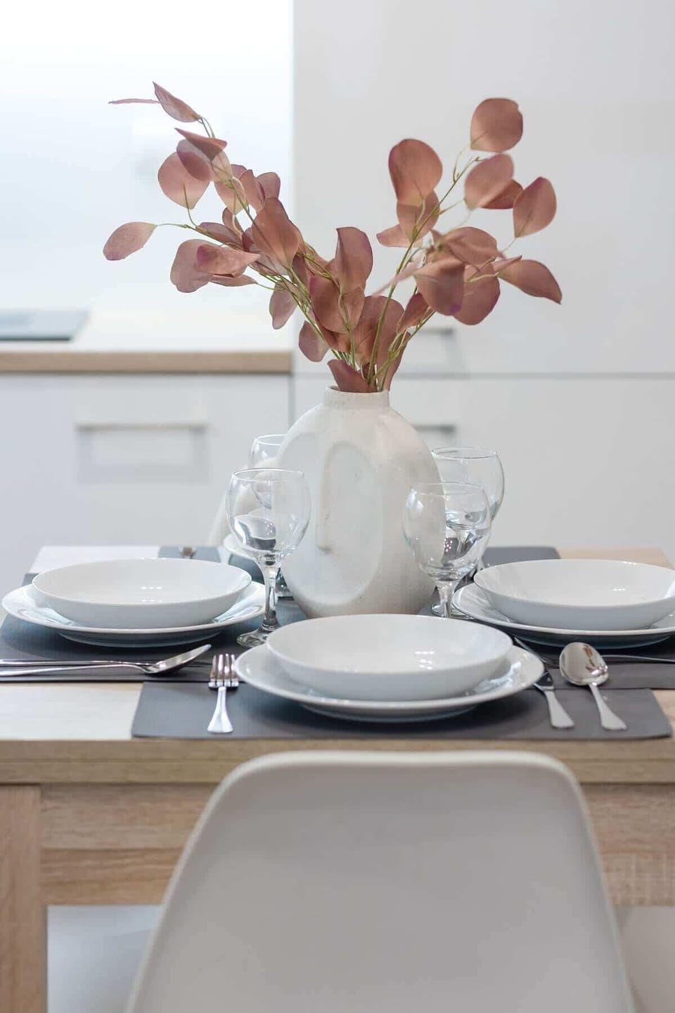 A close-up of a dining table set elegantly with plates and a centerpiece, enhancing the apartment's inviting ambiance.

