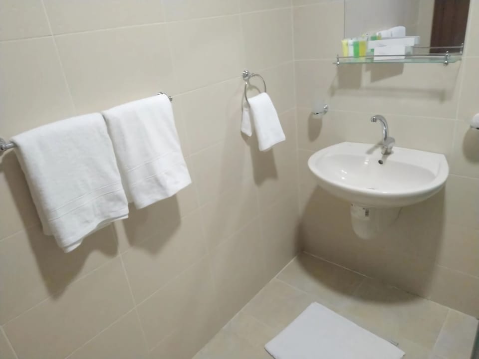 Combined shower/tub, designer toiletries, bathrobes, slippers