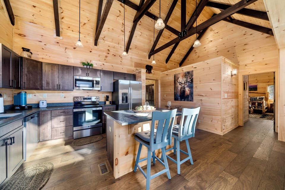 Rustic-chic cabin kitchen with vaulted ceilings and island seating