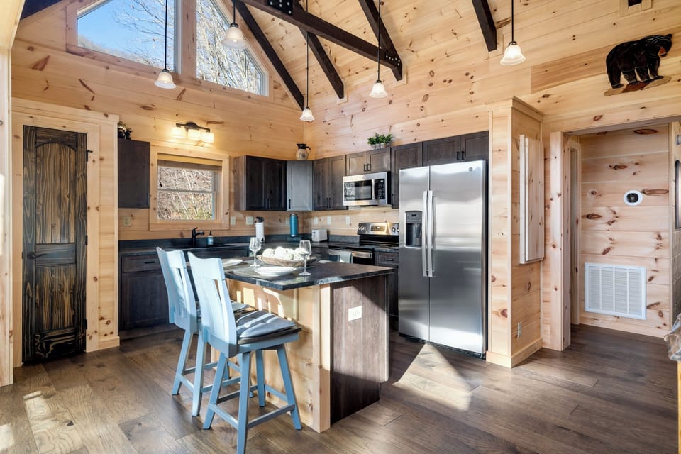 Bright vaulted cabin kitchen with island seating and modern finishes