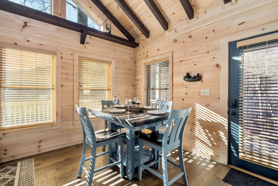 Sunny rustic dining nook with vaulted wood ceilings and seating for four