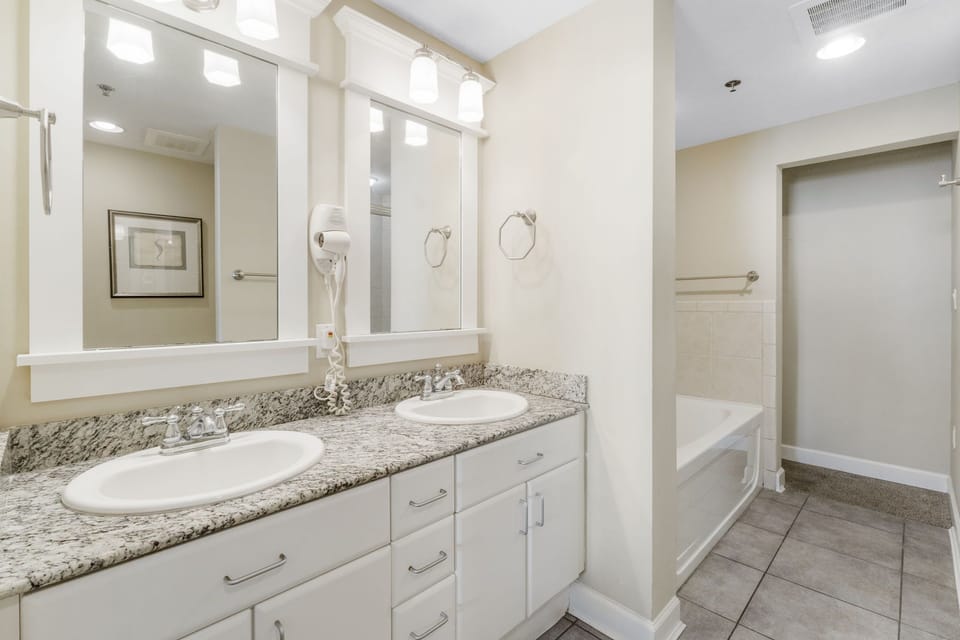 Modern bathroom with dual sinks and granite countertop