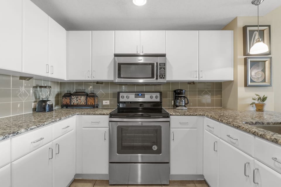 Modern kitchen with stainless steel appliances and granite countertops