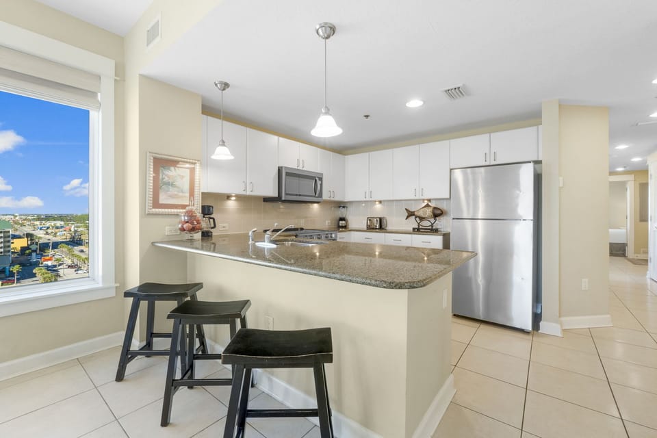 Modern kitchen with granite countertops and stainless steel appliances.