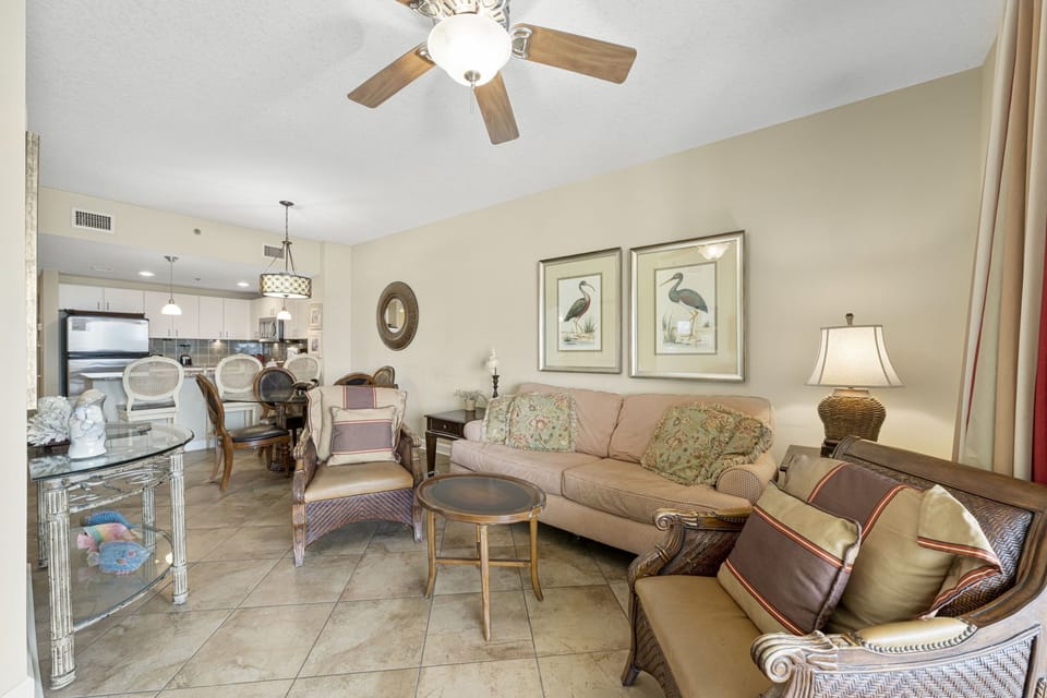 Comfortable living area with seating and open kitchen in a neutral color scheme