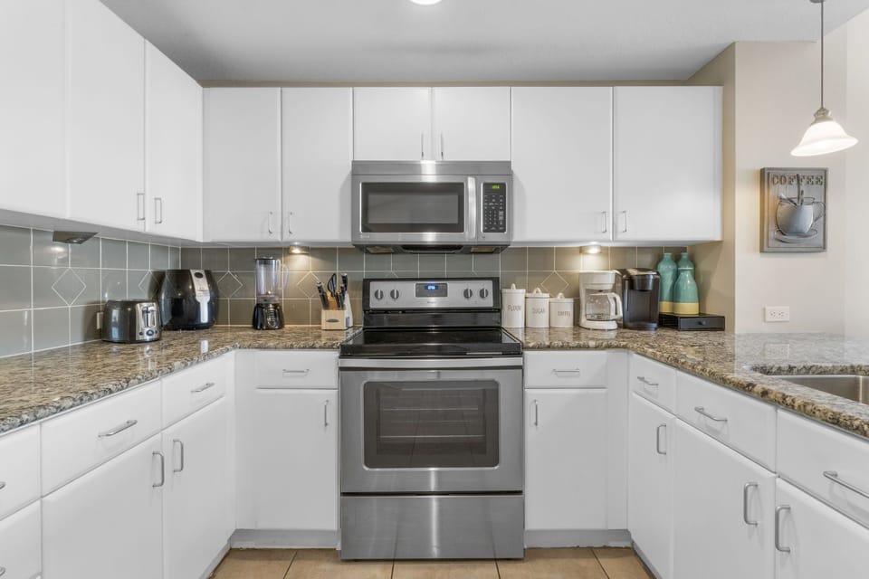 Modern kitchen with stainless steel appliances and granite countertops