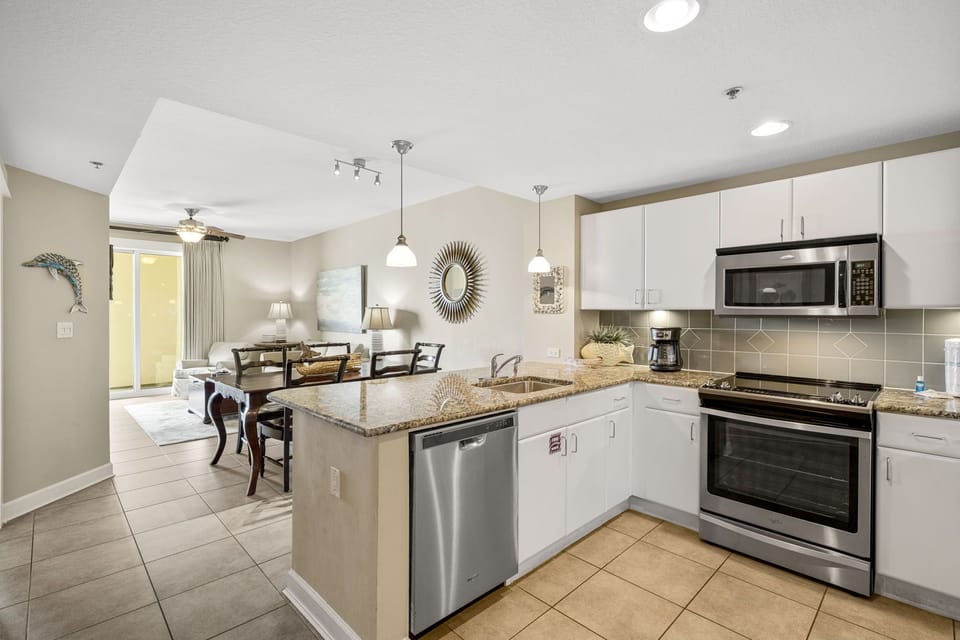 Modern kitchen with stainless steel appliances and an open layout connecting to the dining area