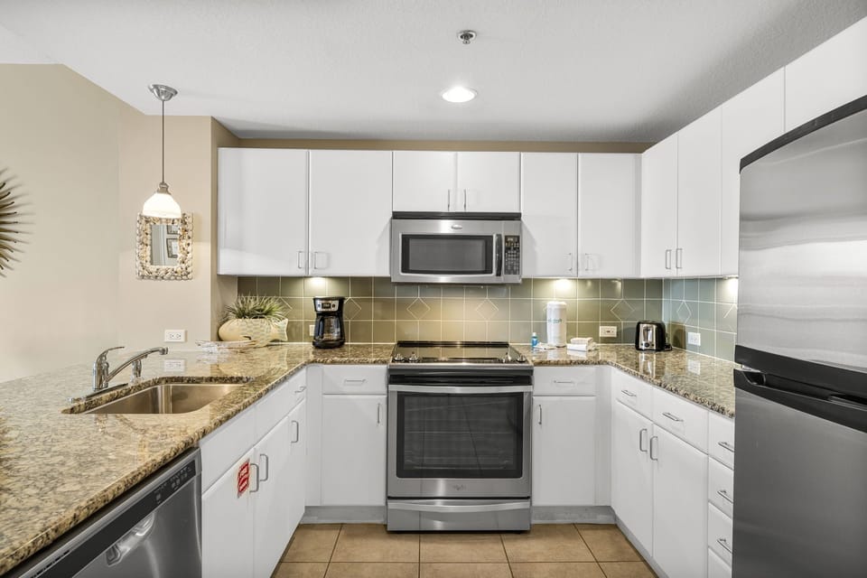Modern kitchen with stainless steel appliances and granite countertops
