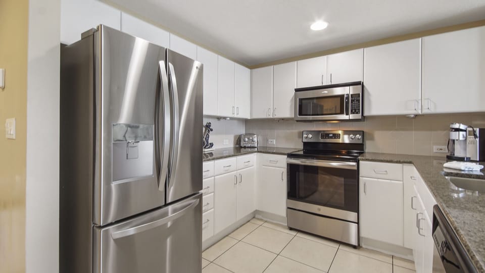 Modern kitchen with stainless steel appliances and white cabinetry