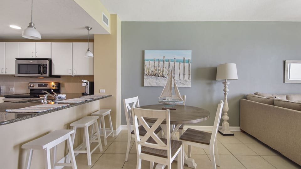 Modern dining area with coastal decor and an open kitchen layout