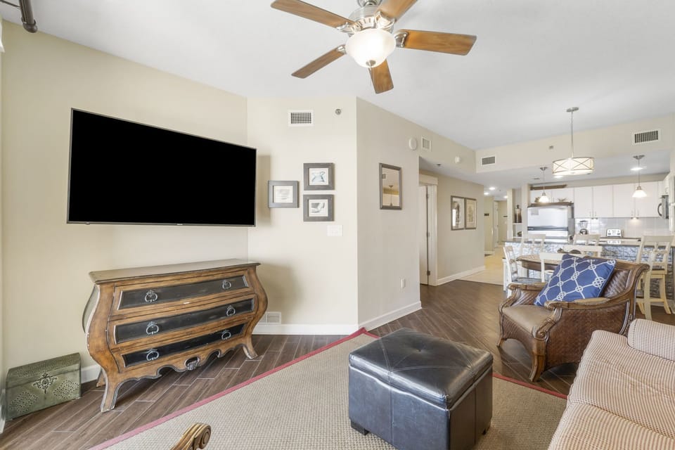 Open living area with a mounted flat-screen tv and classic wooden furniture