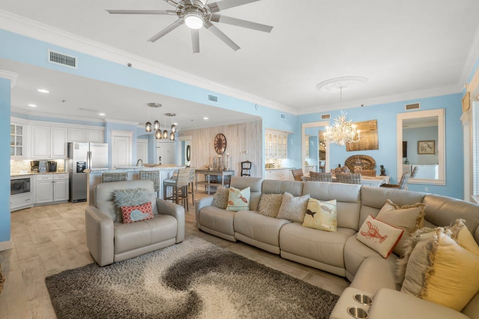 Spacious open-concept living area with modern furnishings and a connected kitchen.