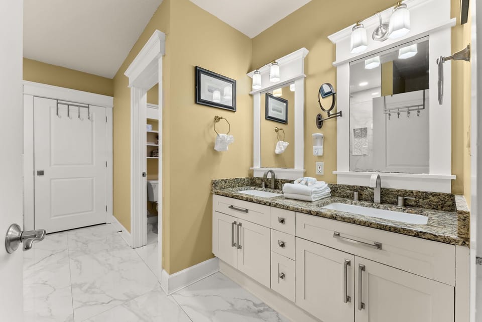 Spacious bathroom with dual sinks and granite countertops.