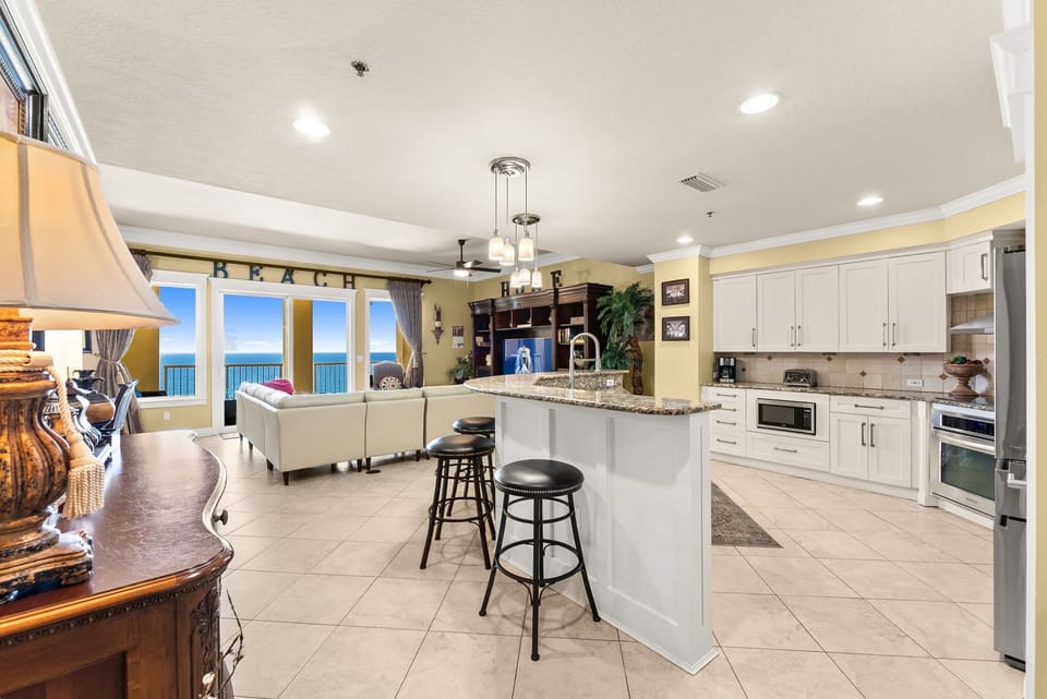 Open kitchen and living area with ocean views through large windows.