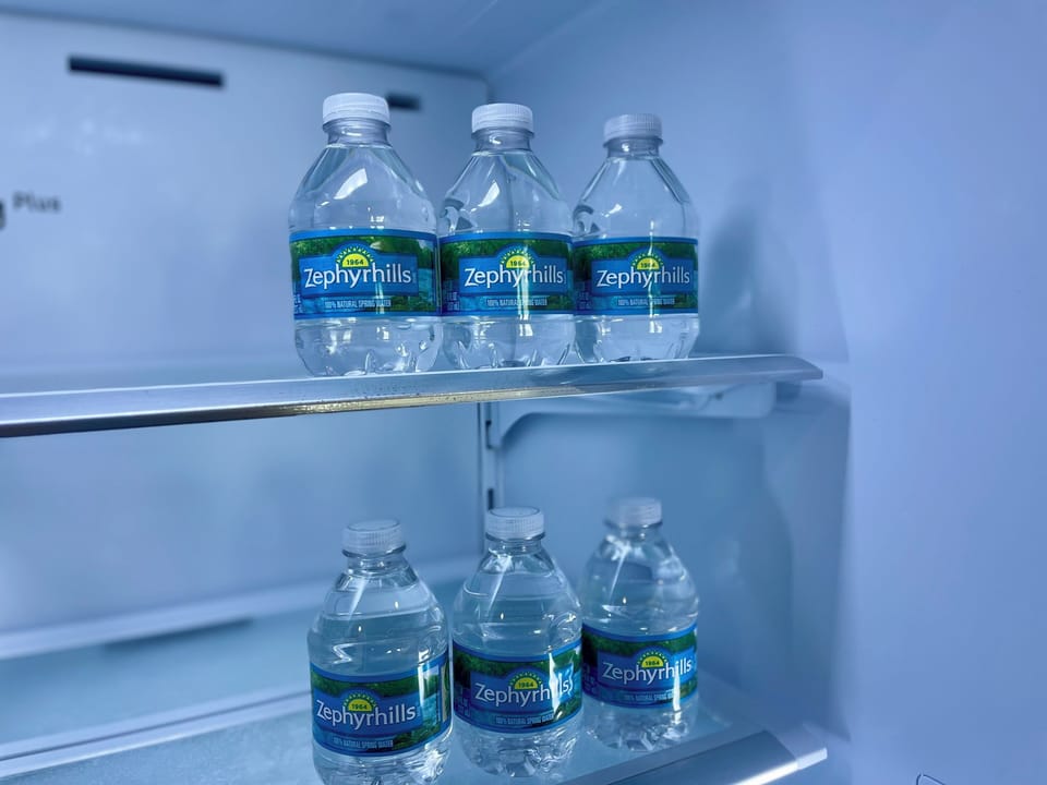Bottled water provided in the refrigerator for guest convenience.