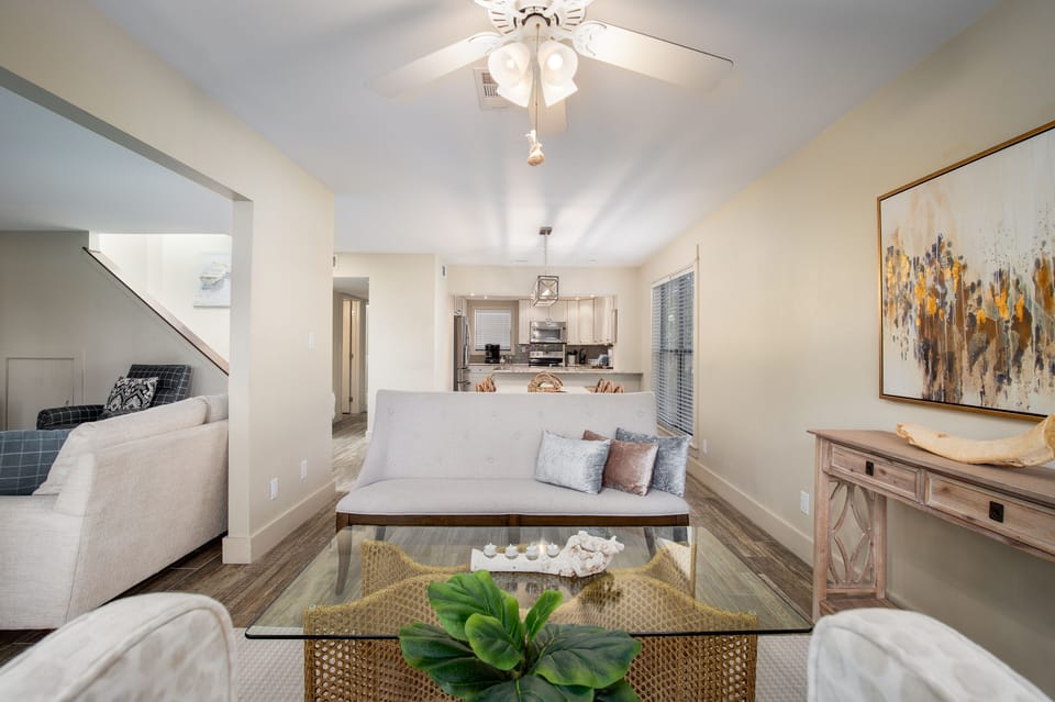Unwind in your open-concept living space featuring plush seating, elegant decor, and seamless flow to the modern kitchen.