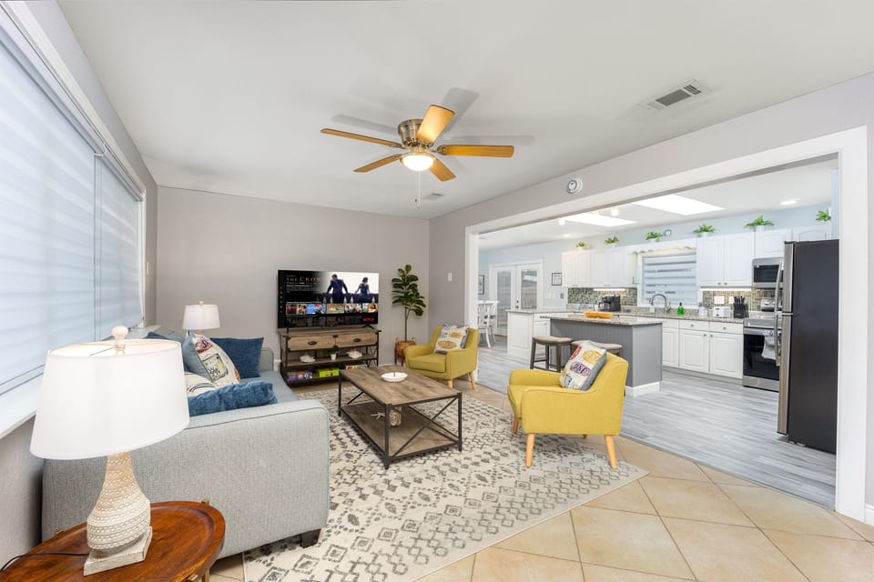 Relax and unwind in our living room, featuring a 58-inch Roku TV. The hideaway couch features a Queen-Size mattress, offering extra sleeping space. The open layout seamlessly connects to the kitchen and dining area, making it perfect for socializing.