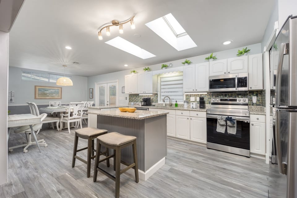 The kitchen island with two stools is perfect for casual dining or chatting while you cook, and it all flows openly into the dining and living areas for easy entertaining.