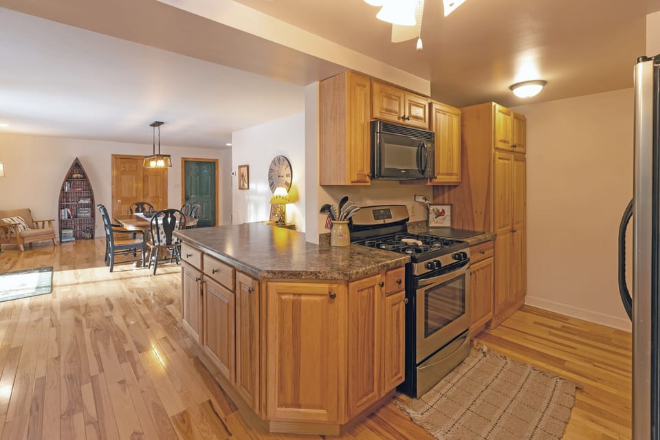 Kitchen area with stove and microwave