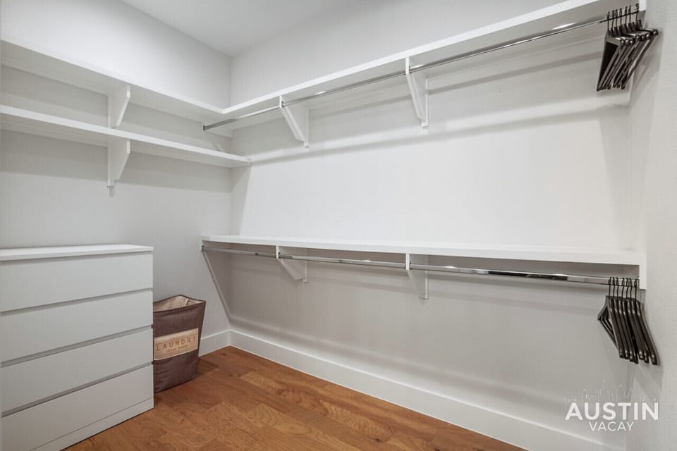 Spacious walk in closet located in the primary bathroom