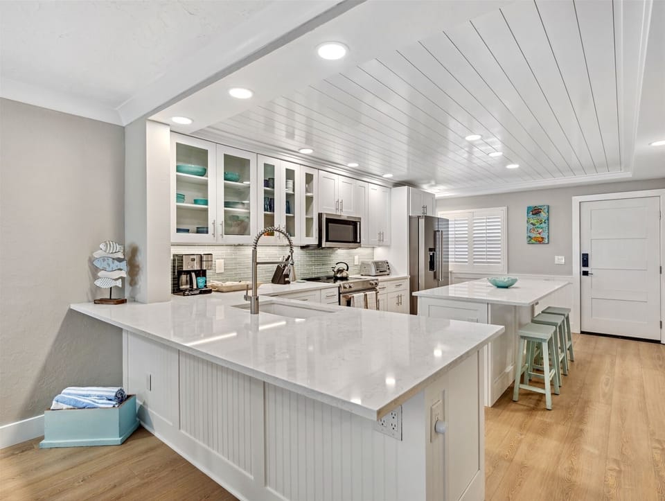 Gourmet kitchen with breakfast bar, shiplap ceiling, island
