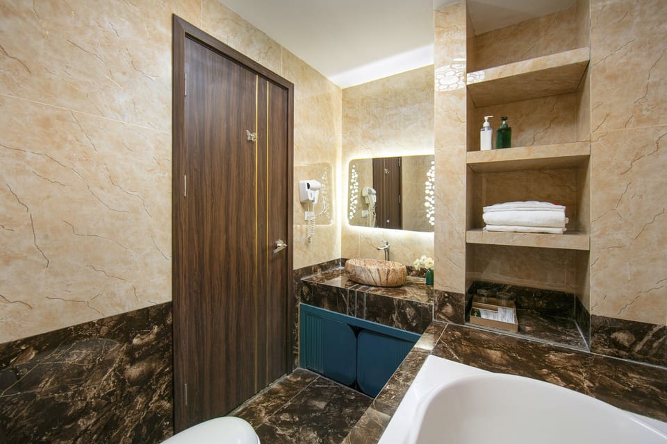 Separate tub and shower, rainfall showerhead, designer toiletries