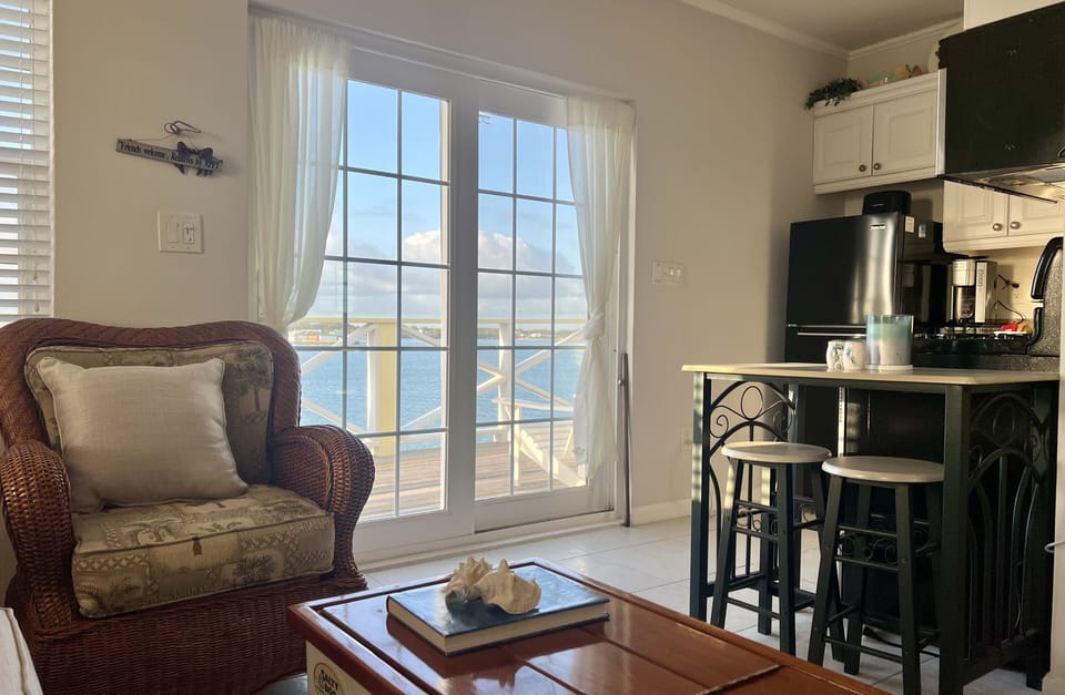 View of upstairs living room, kitchenette and deck