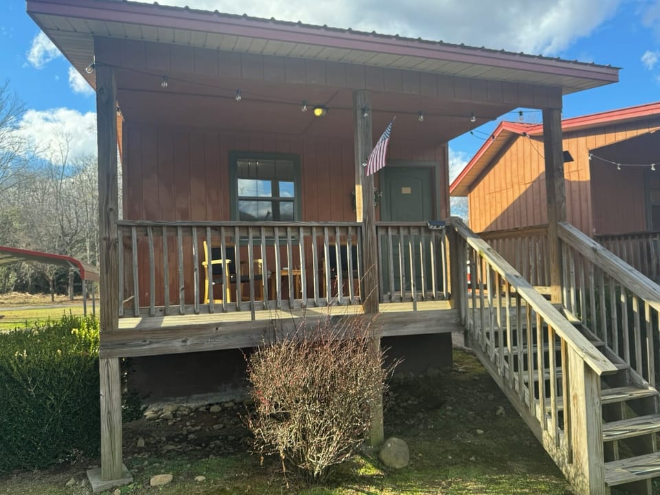 Each Cabin offers an inviting front porch with seating to enjoy the view