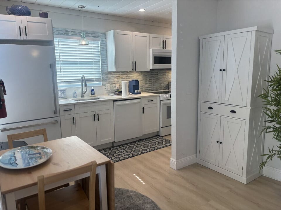 Kitchen with pantry storage and dining area.