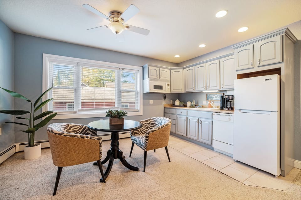 Ground-level kitchenette with coffee machines, fridge, and essentials 