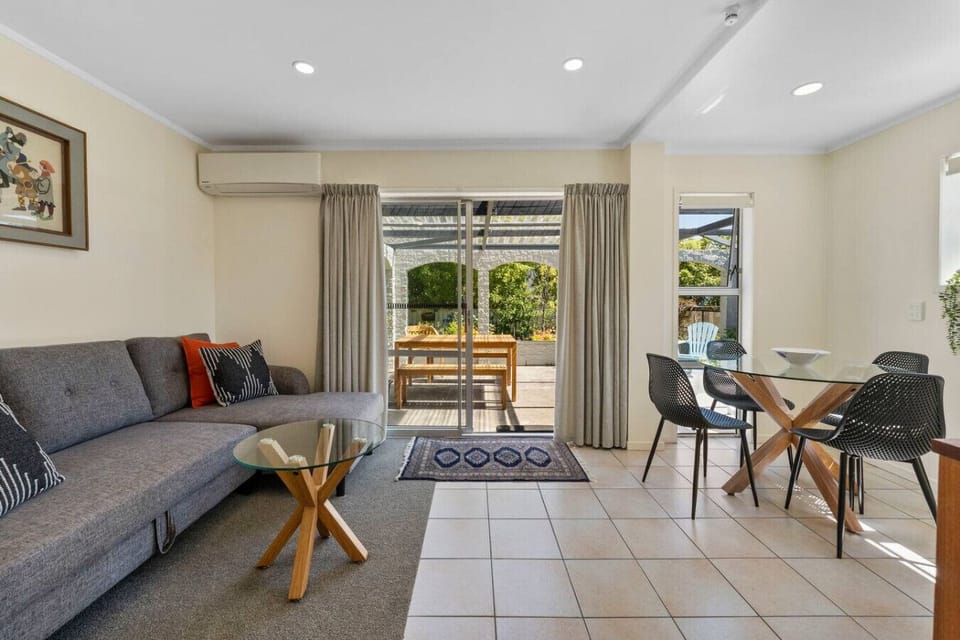 Lounge with dining area and kitchenette, with sofa bed